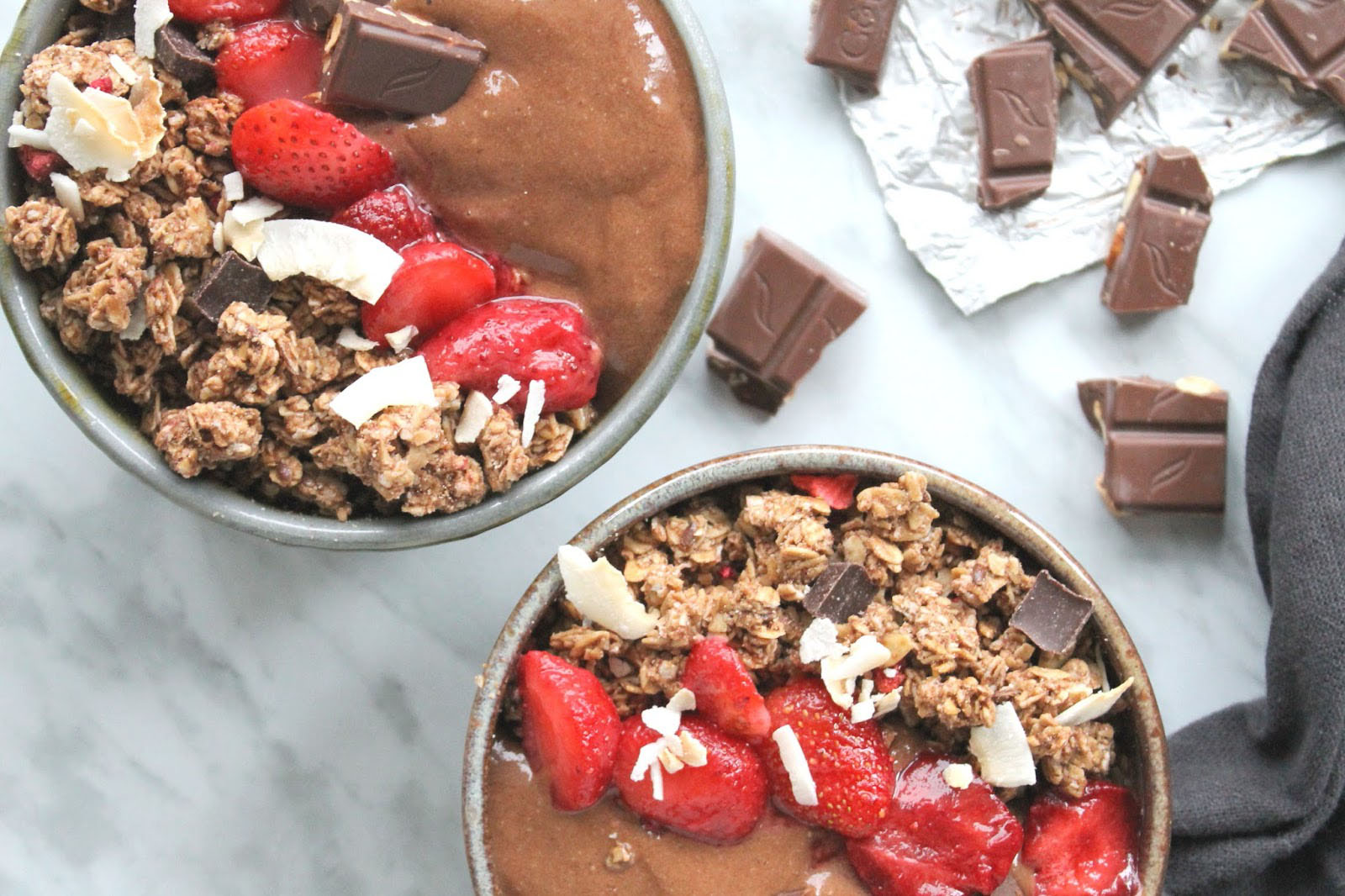 chocolate smoothie bowls with fruit and granola on top