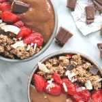 chocolate smoothie bowls with fruit and granola on top