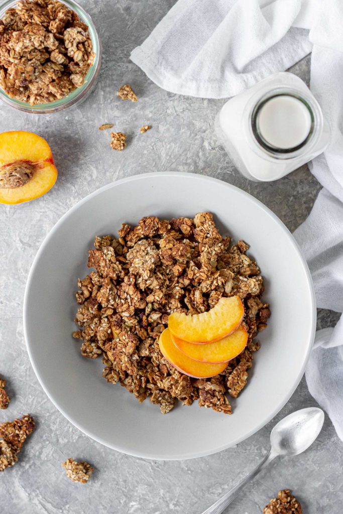 bowl of almond butter granola with peaches